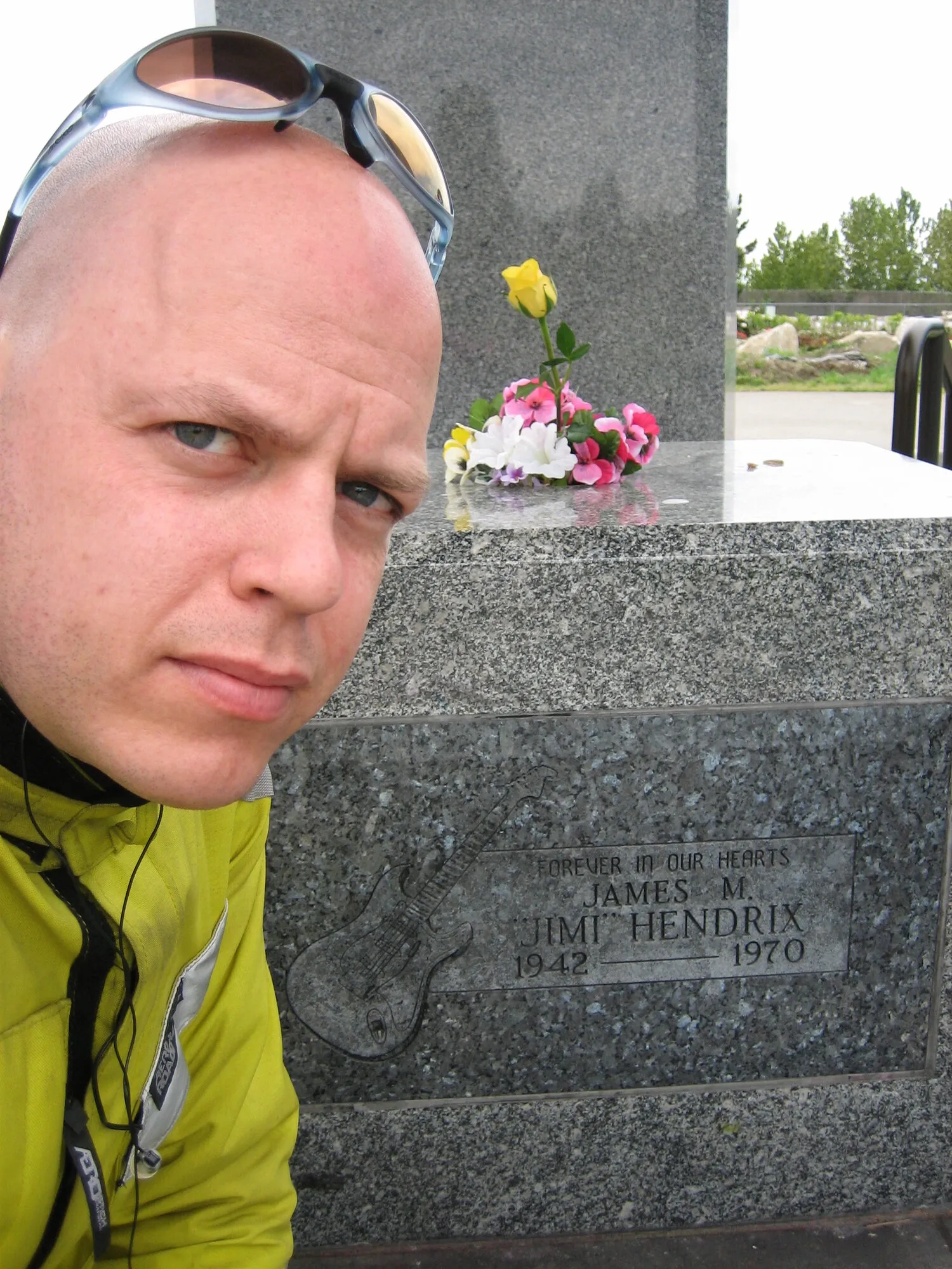 Stephen beside the granite grave marker of Jimi Hendrix in Renton, Washington